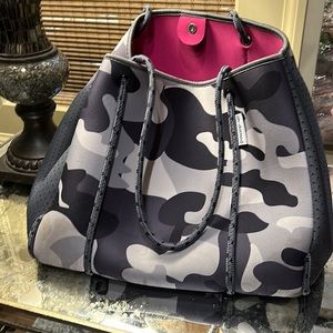 Ah-dorned! Large gray camo bag with hot pink inside.